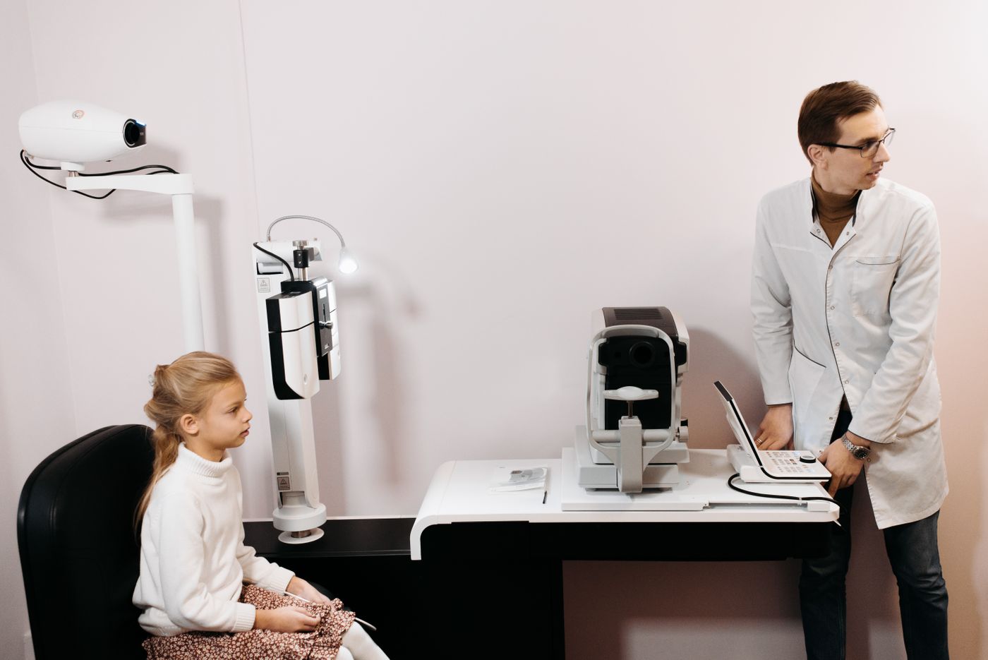 Optometrist conducting an eye examination in a modern consulting room