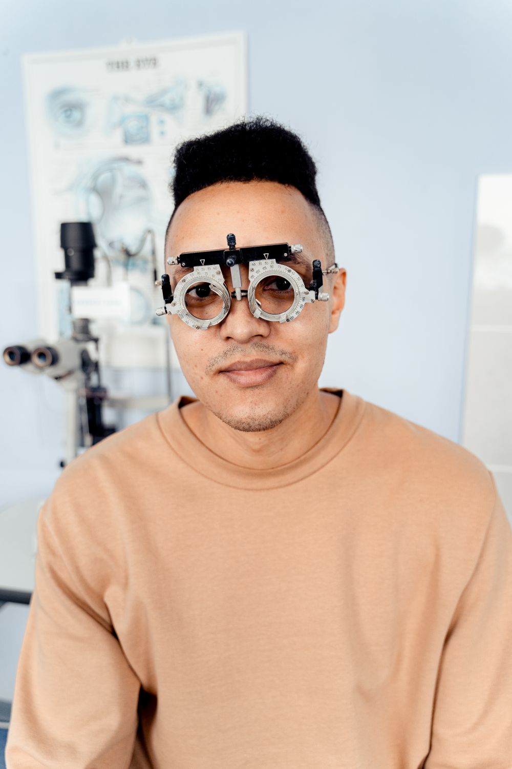 Optometrist adjusting trial frames during an eye test